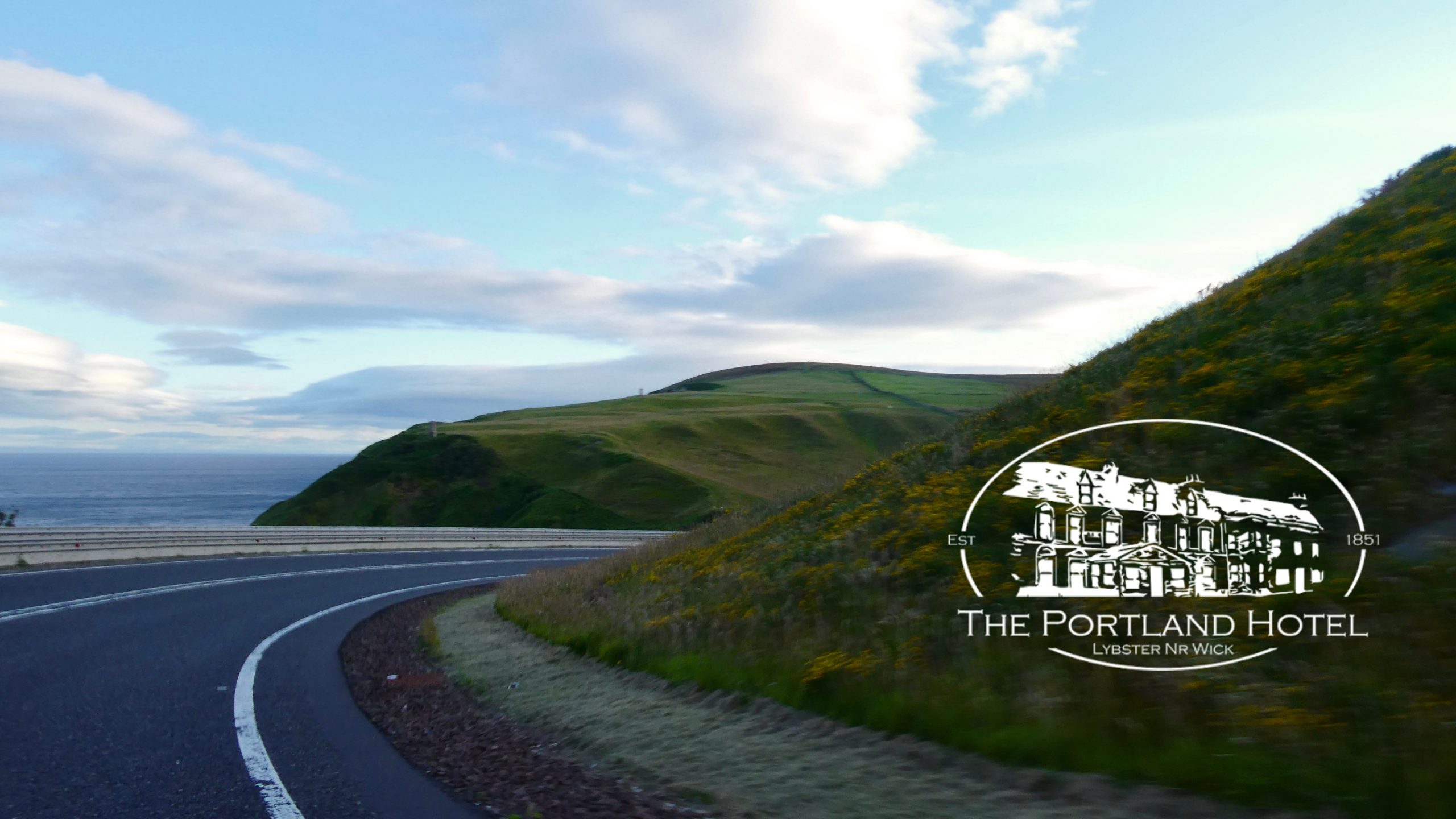 Photo: coastal road with hills and sea, Welcome hero background